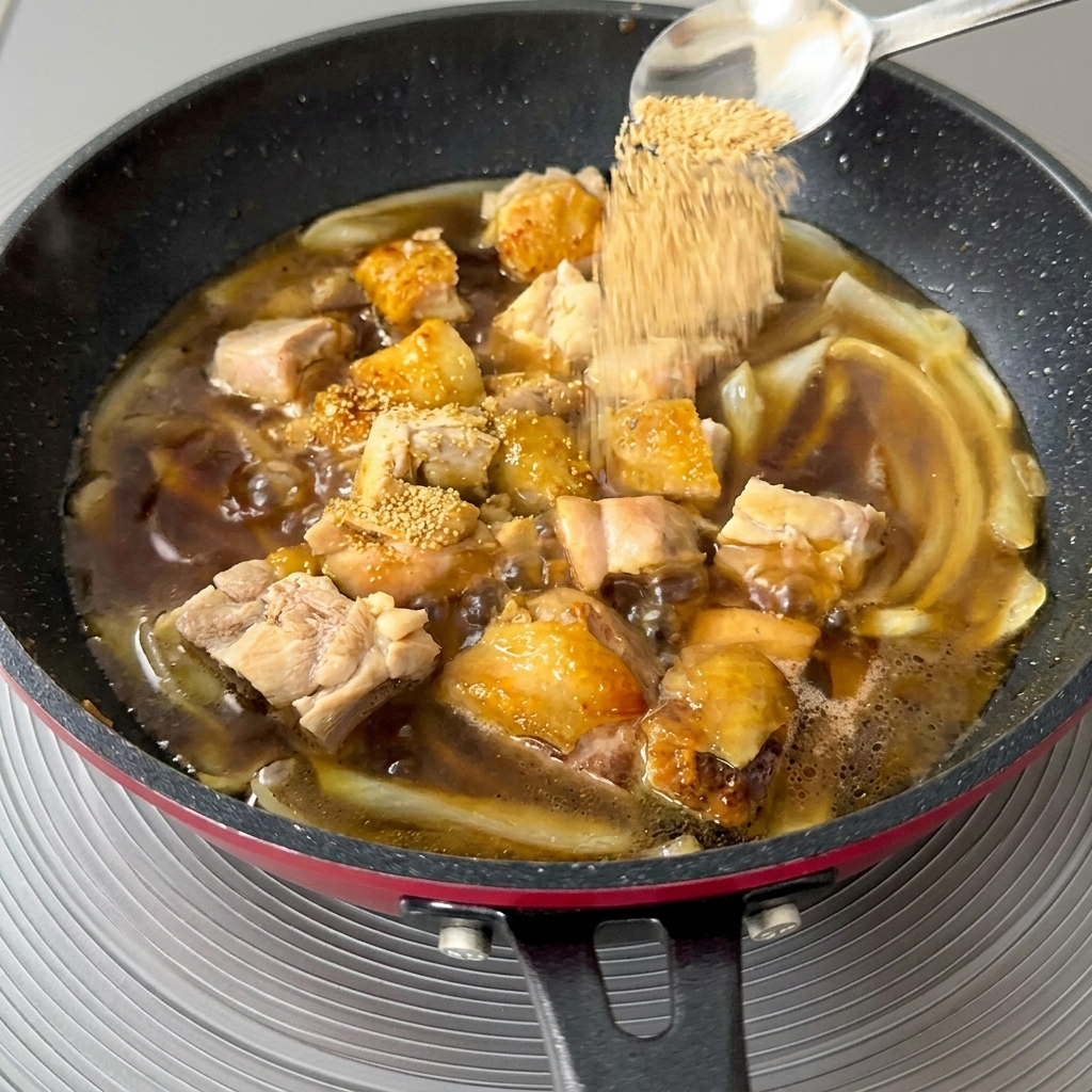 Cuchara añadiendo gránulos de dashi a la sartén en ebullición.