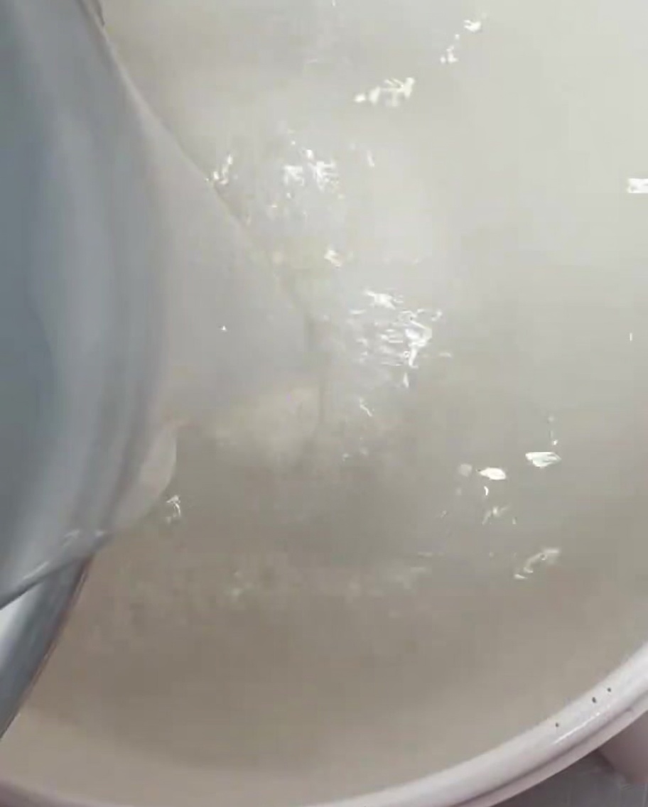 Agua de arroz blanca y clara vertida en una olla grande.