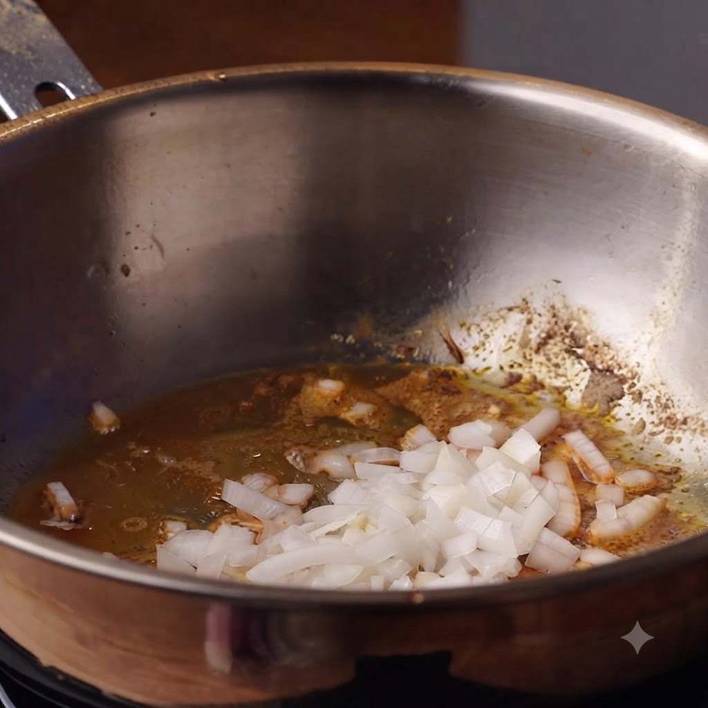 Cebollas picadas y ajo cocinándose en aceite dentro de una olla profunda.