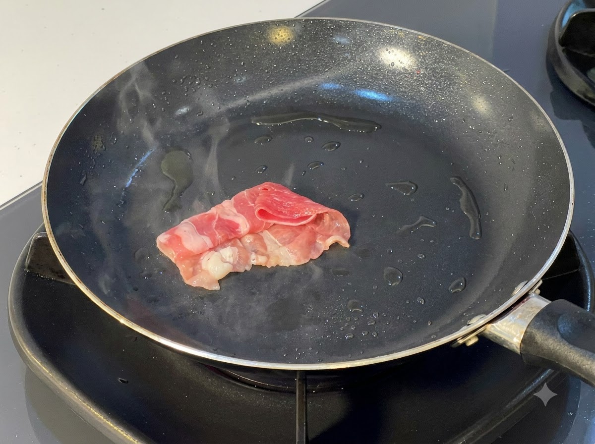 Filetes de ternera enrollados siendo colocados y sellados en una sartén caliente con aceite.