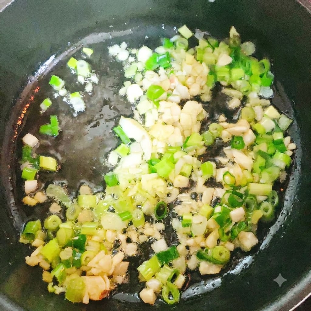 Cabeza y cola de abadejo sofriéndose en una olla con aromáticos.